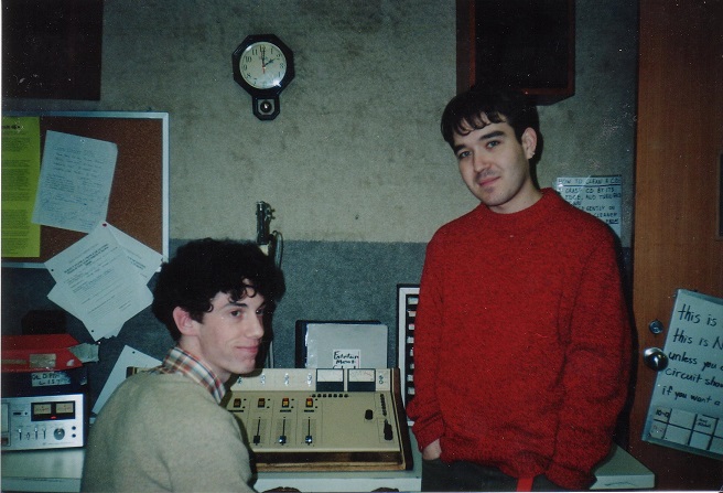two cute young disc jockeys at a community radio station